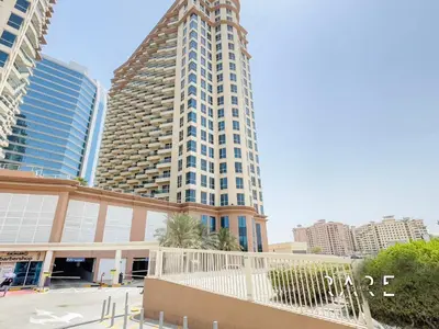 a tall building in the middle of a city at Rare Holiday Homes - The Crescent Tower - IMPZ - Dubai Production City - R705 in Dubai