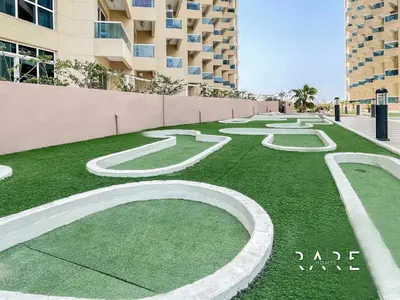 a grassy area with white numbers on top of it at Rare Holiday Homes - The Crescent Tower - IMPZ - Dubai Production City - R705 in Dubai