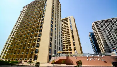 two tall buildings in a city with a blue sky at Rare Holiday Homes - Near The Lake - Lago Vista B - Dubai Production City - IMPZ - R2112 in Dubai