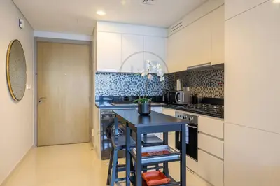 a kitchen with a blue island in a room at Designer 1BR on High Floor Downtown Vibes in Dubai
