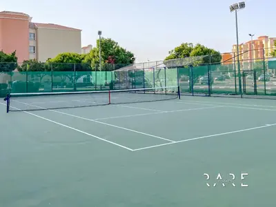 a tennis net on a tennis court at Rare Holiday Homes - Mediterranean Cluster - Near Ibn Battuta Mall - Discovery Garden - Building# Med 49 - R411 in Dubai