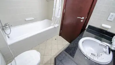 a bathroom with a toilet and a tub and a sink at Rare Holiday Homes - Mediterranean Cluster - Near Ibn Battuta Mall - Discovery Garden - Building# Med 49 - R411 in Dubai