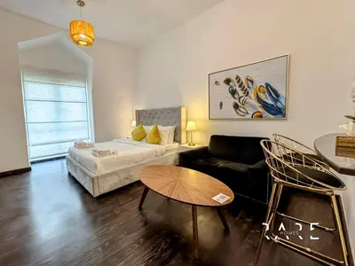 a living room with a couch and a table at Rare Holiday Homes - Mediterranean Cluster - Near Ibn Battuta Mall - Discovery Garden - Building# Med 49 - R505 in Dubai