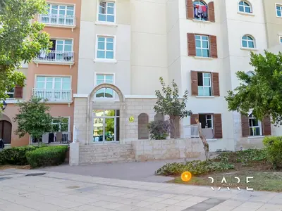 an apartment building with an orange light in front of it at Rare Holiday Homes - Mediterranean Cluster - Near Ibn Battuta Mall - Discovery Garden - Building# Med 79 - R203 in Dubai