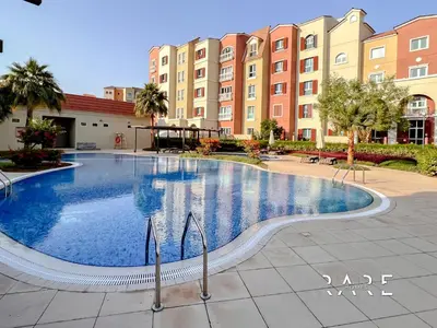 a large swimming pool in front of a building at Rare Holiday Homes - Mediterranean Cluster - Near Metro - Discovery Garden - Building# Med 103 - RG07 in Dubai
