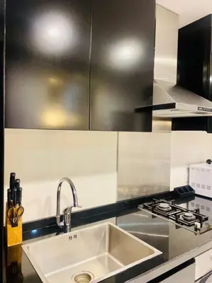 a kitchen with a sink and a stove at Downtown Studio - Cour Jardin in Dubai