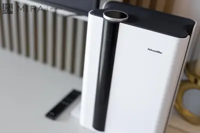 a black and white phone sitting on a desk at Mira Holiday Homes - Luxury 2 bedroom in Le Pont in Dubai