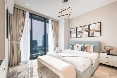 a bedroom with a large bed and a large window at Waterfront Living 2BR Apartment in Marina Star, Dubai Marina by Deluxe Holiday Homes in Dubai