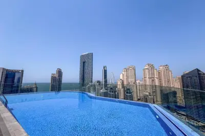 a large swimming pool on the roof of a building at Waterfront Living 2BR Apartment in Marina Star, Dubai Marina by Deluxe Holiday Homes in Dubai