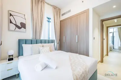 a bedroom with a white bed and a window at Luxurious 2BR Apartment in Azizi Riviera 18, Al Merkadh by Deluxe Holiday Homes in Dubai