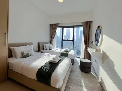 two beds in a hotel room with a window at 2BR Stunning Full Burj Khalifa View in Dubai