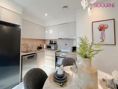a kitchen with a table with a vase on it at 2BR Stunning Full Burj Khalifa View in Dubai