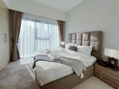 a bedroom with a large bed and a large window at 2BR Stunning Full Burj Khalifa View in Dubai