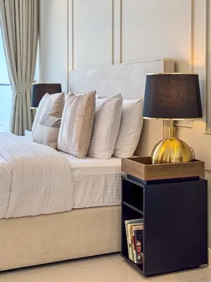 a bedroom with a bed with a lamp on a night stand at 3 King Beds - 7mins to Dubai Mall - High Floor Sun Set and Sea View in Dubai