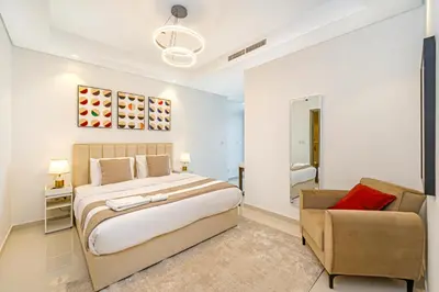a bedroom with a large bed and a couch at 3 King Beds - 7mins to Dubai Mall - High Floor Sun Set and Sea View in Dubai