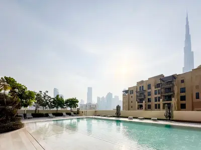 a swimming pool with a city skyline in the background at Breathtaking Burj View, Sky High Luxury 2BR Apartment by 2nd Best Home in Dubai