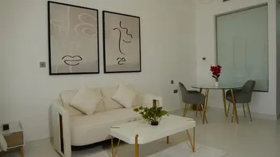 a living room with a couch and a table at Dimorelux l Club Vista Mare l Five Palm Jumeirah in Dubai