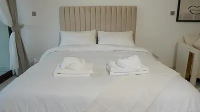 a white bed with towels on top of it at Dimorelux l Club Vista Mare l Five Palm Jumeirah in Dubai