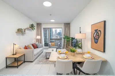 a living room with a table and a couch at Boulevard 2 BR- Burj Khalifa-Dubai Mall- pool-Gym in Dubai