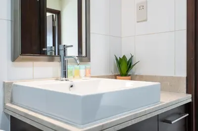 a white sink in a bathroom with a mirror at Boulevard 2 BR- Burj Khalifa-Dubai Mall- pool-Gym in Dubai