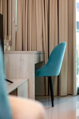 a blue chair sitting in front of a desk at Popular Seven Palm Apartments in Dubai