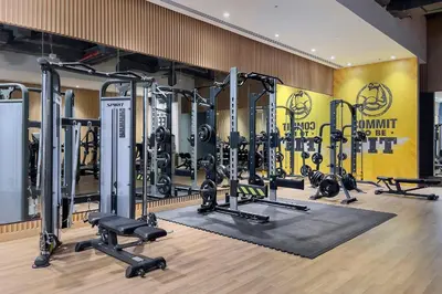 a gym with a lot of treadmills and weights at Popular Seven Palm Apartments in Dubai