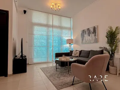 a living room with a couch and a table at Rare Holiday Homes - Near Madame Tussauds - DEC Tower 1 - Dubai Marina - R2008 in Dubai