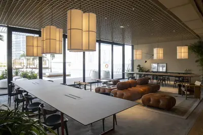 a large room with tables and chairs and large windows at Modern Studio at Upside Living, Business Bay with Burj Khalifa View in Dubai
