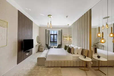 a hotel room with a bed and a television at Durrani Homes - Heaven on Earth collection 4BR with panorama Burj khalifa and fountain views in Dubai