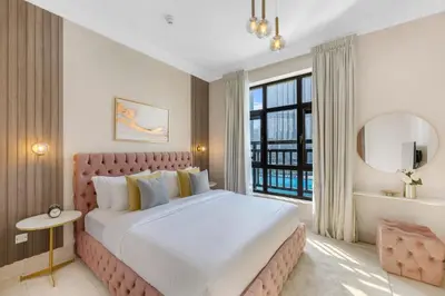 a bedroom with a large bed and a large window at Durrani Homes - Heaven on Earth collection 4BR with panorama Burj khalifa and fountain views in Dubai
