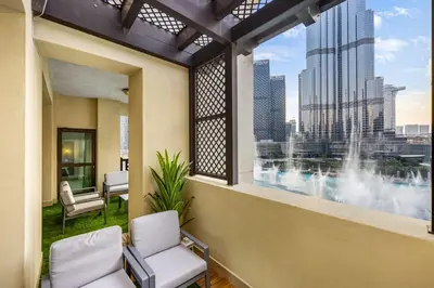 a balcony with two chairs and a view of a city at Durrani Homes - Heaven on Earth collection 4BR with panorama Burj khalifa and fountain views in Dubai
