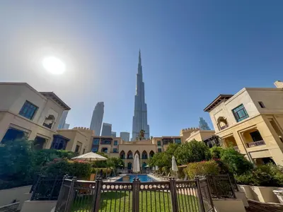 a view of the burj khalifa from the courtyard of a building at Durrani Homes - Heaven on Earth collection 4BR with panorama Burj khalifa and fountain views in Dubai