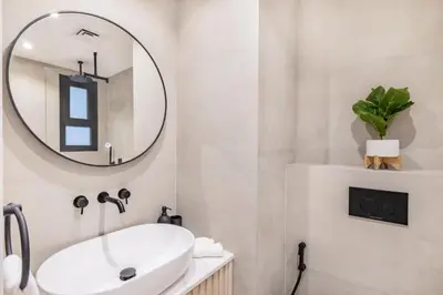a bathroom with a sink and a mirror at Luxury Palm Villa with Beach Access -Rooftop Garden & Resort Style Pool by Exclusive Holiday Homes in Dubai