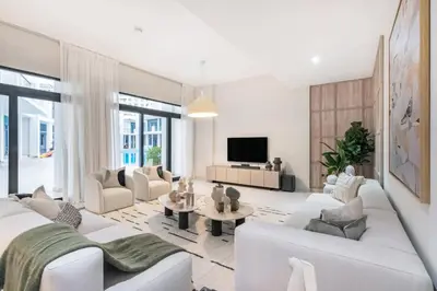 a living room with white furniture and a flat screen tv at Luxury Palm Villa with Beach Access -Rooftop Garden & Resort Style Pool by Exclusive Holiday Homes in Dubai