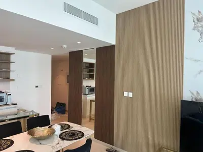a kitchen and dining room with a table and chairs at Stylish 2 BR Apt, Amazing Fountains and Burj Views in Dubai