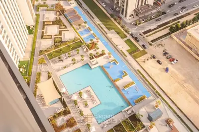 an overhead view of a swimming pool in a city at Stylish 2 BR Apt, Amazing Fountains and Burj Views in Dubai