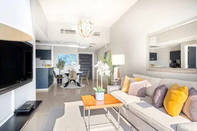 a living room with a white couch and a table at Silkhaus Modern 1BDR near Almas in East Lake in Dubai