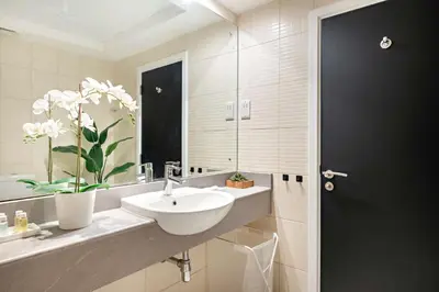 a bathroom with a sink and a mirror at Silkhaus Modern 1BDR near Almas in East Lake in Dubai