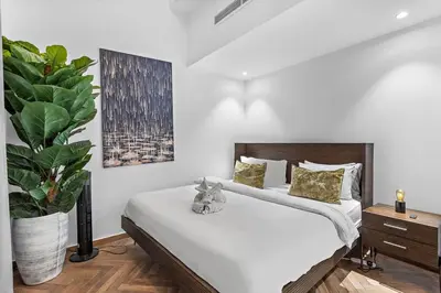 a bedroom with a bed and a potted plant at Bright 3BR Apartment in JBR Close to Beach & Shops in Dubai