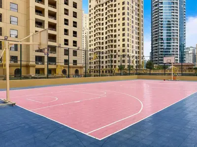 a basketball court in a city with tall buildings at Bright 3BR Apartment in JBR Close to Beach & Shops in Dubai