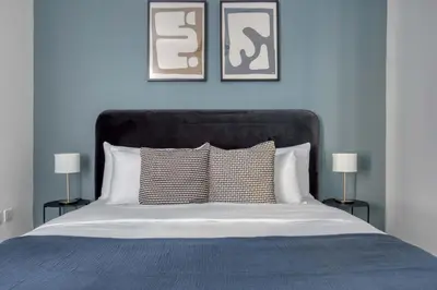 a bedroom with a bed with two pictures on the wall at Blueground Marina Pool Gym DXB-221 in Dubai
