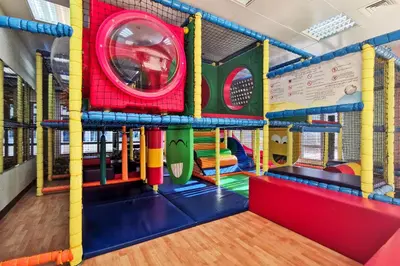 a brightly colored indoor play room with a playground at Blueground Marina Pool Gym DXB-237 in Dubai