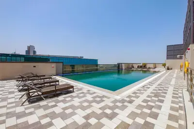 a swimming pool on the roof of a building at Blueground Duja Tower City View pool gym DXB-1108 in Dubai