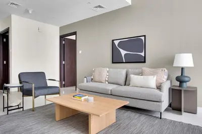 a living room with a couch and a coffee table at Blueground Duja Tower City View pool gym DXB-1108 in Dubai
