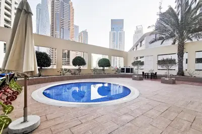 a large swimming pool in the middle of a building at Blueground The Royal Oceanic pool gym DXB-1152 in Dubai