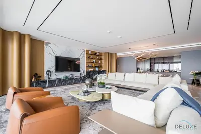 a living room with white furniture and a tv at Picturesque 3BR with Assistant Room in The One JBR by Deluxe Holiday Homes in Dubai