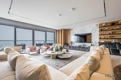 a living room with a white couch and a fireplace at Picturesque 3BR with Assistant Room in The One JBR by Deluxe Holiday Homes in Dubai