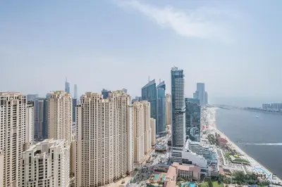 an aerial view of a city with tall buildings at Picturesque 3BR with Assistant Room in The One JBR by Deluxe Holiday Homes in Dubai