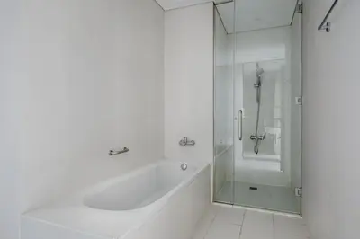a white bathroom with a tub and a shower at Blueground DIFC indoor pool fitness center DXB-1515 in Dubai