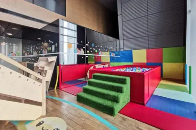 a colorful room with a bunk bed and a staircase at Blueground DIFC indoor pool fitness center DXB-1515 in Dubai